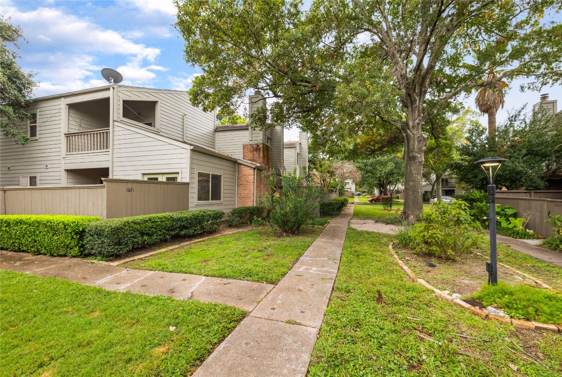 1621 Prairie Mark Lane Houston, TX 77077 - Photo 4 of 26 a front view of a house with a yard