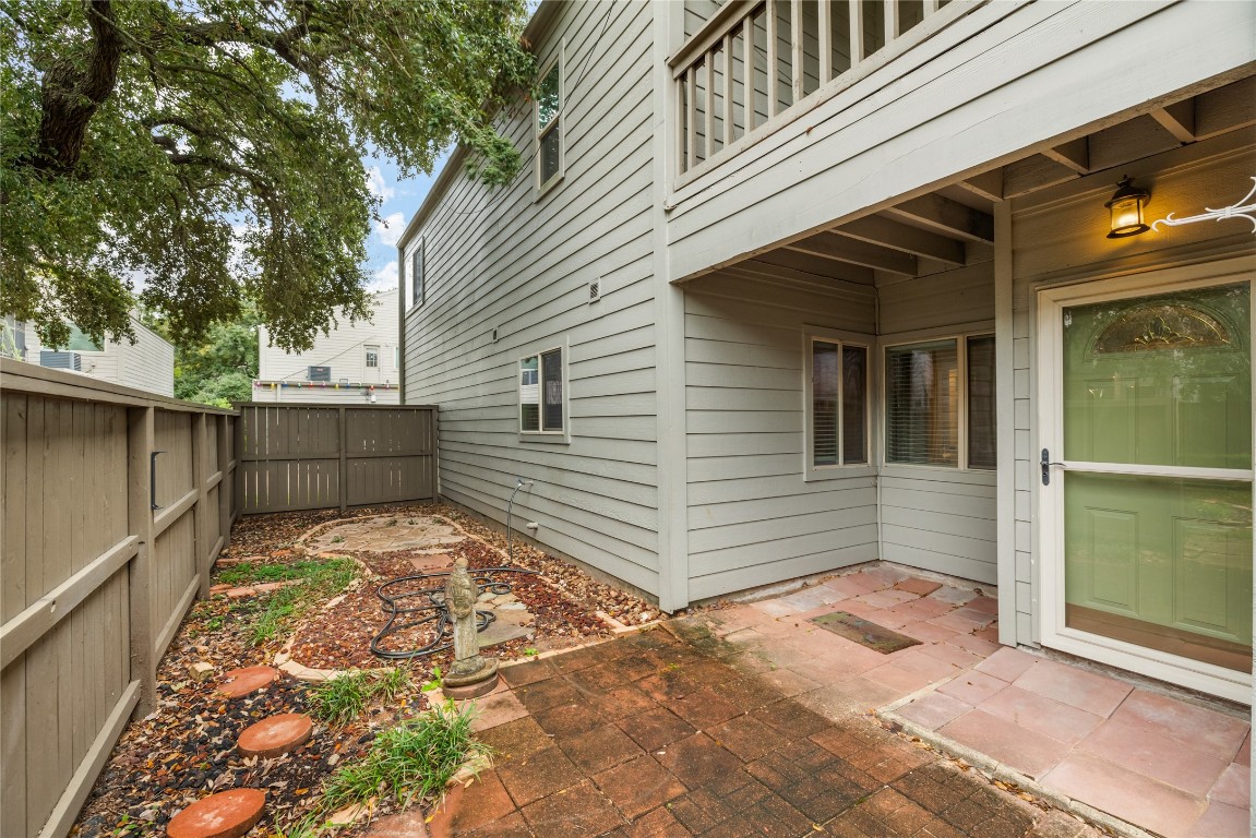 1621 Prairie Mark Lane Houston, TX 77077 - Photo 5 of 26 a view of a backyard with a large tree
