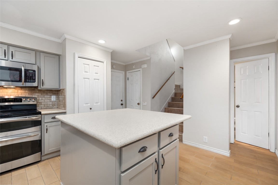 1621 Prairie Mark Lane Houston, TX 77077 - Photo 9 of 26 a kitchen with a stove a sink and a refrigerator