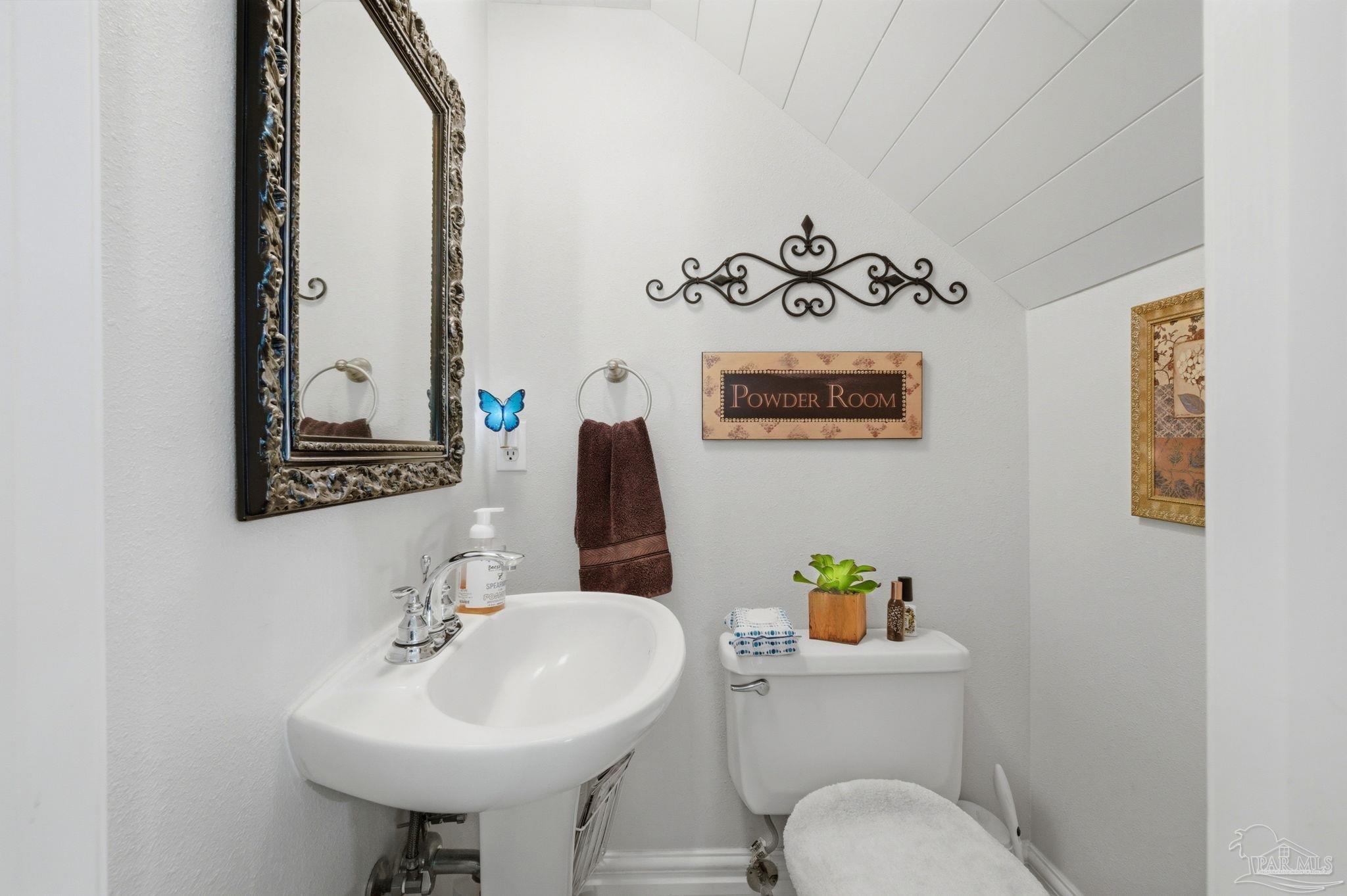 6930 Summit Way Milton, FL 32570 - Photo 42 of 71 a bathroom with a sink a mirror and a toilet