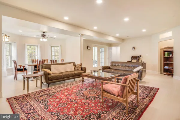 a living room with furniture a rug and a table