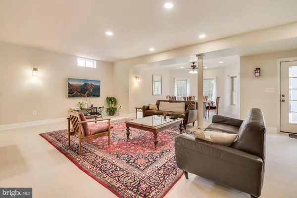 a living room with furniture wooden floor and a flat screen tv
