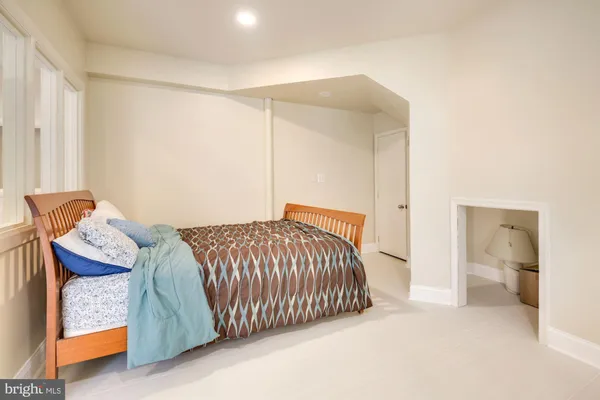 a bedroom with a bed and a couch