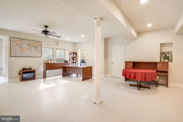a spacious bedroom with a bed and a chandelier