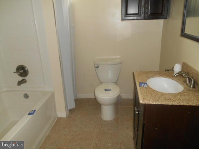 1406 Larch Road Severn, MD 21144 - Photo 11 of 15 a bathroom with a granite countertop sink toilet and shower