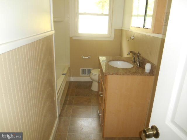 1406 Larch Road Severn, MD 21144 - Photo 8 of 15 a bathroom with a sink and a mirror