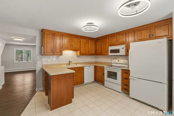 a kitchen with a refrigerator sink and microwave