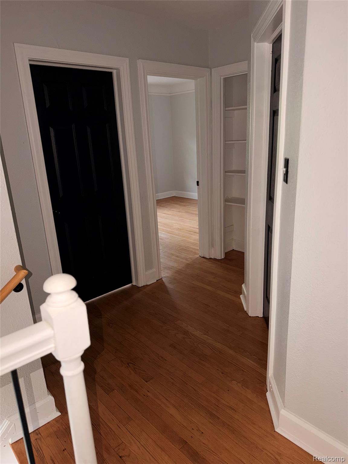 3914 Balfour Road Detroit, MI 48224 - Photo 23 of 24 Hardwood flooring throughout, white baseboards, and built-in shelving