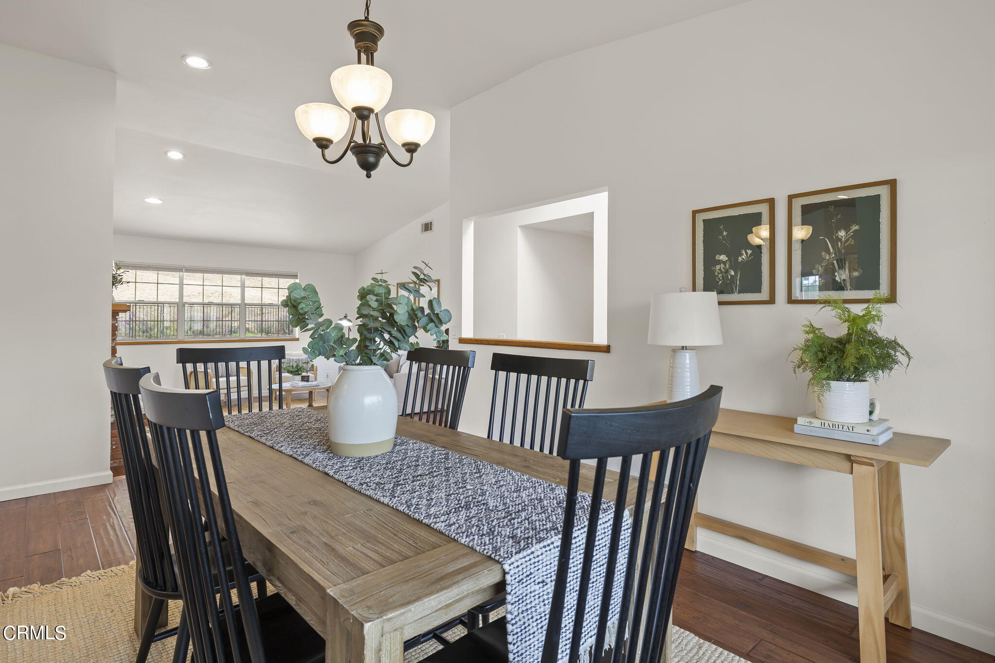 116 Via Pasito Ventura, CA 93003 - Photo 13 of 61 a dining room with wooden floor a chandelier a wooden table and chairs