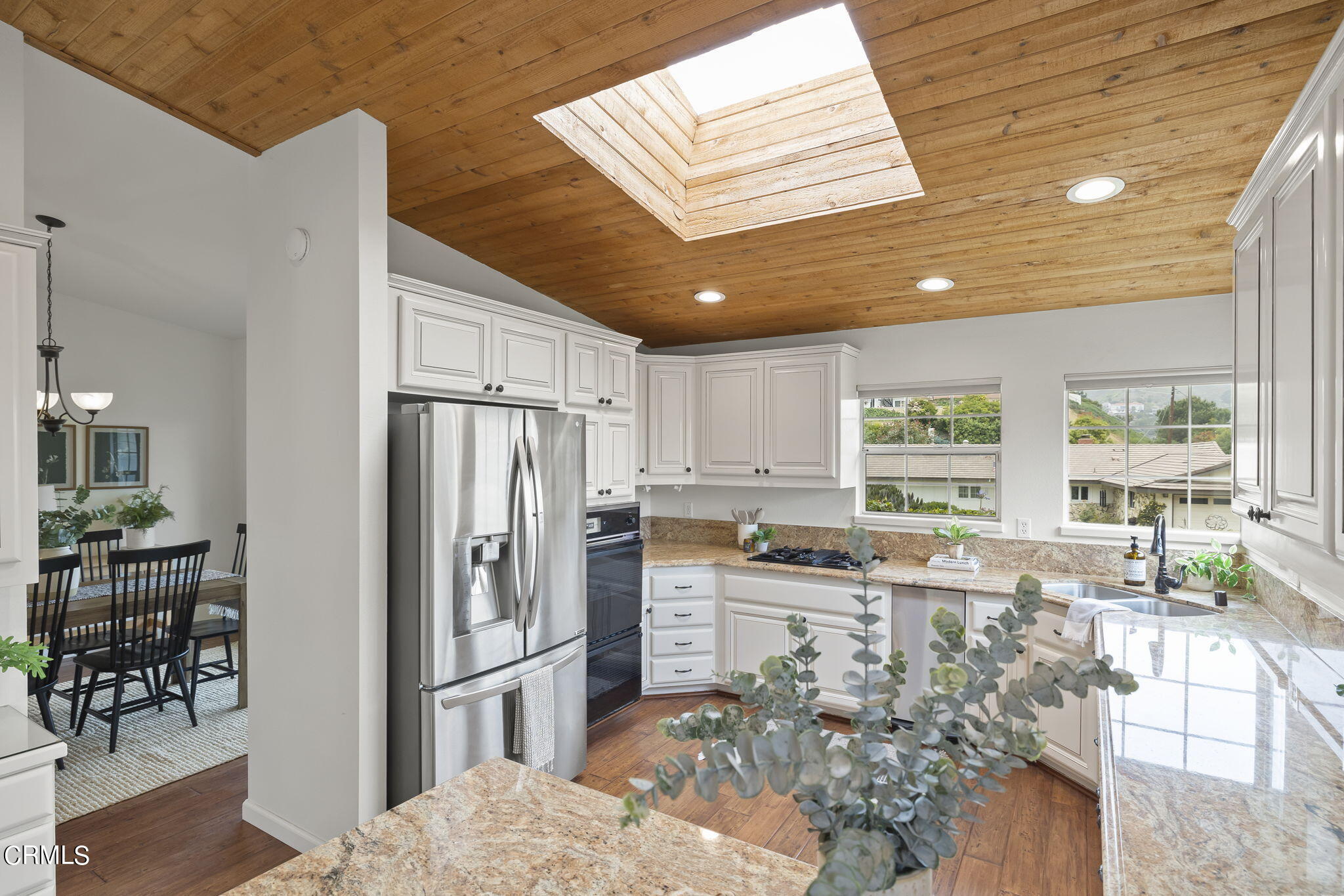 116 Via Pasito Ventura, CA 93003 - Photo 22 of 61 a kitchen with granite countertop a refrigerator and wooden cabinets