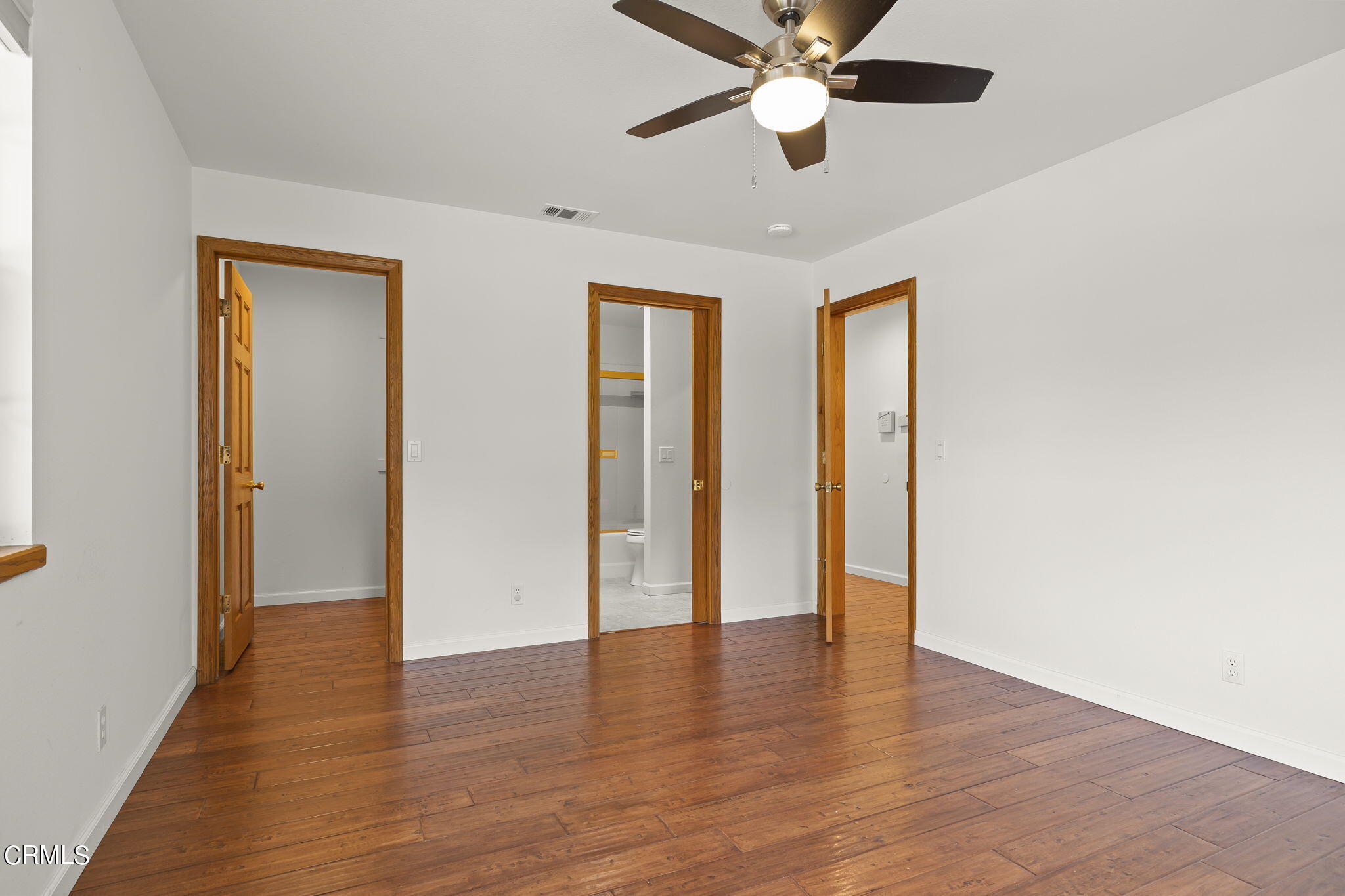 116 Via Pasito Ventura, CA 93003 - Photo 35 of 61 a view of an empty room with wooden floor and a ceiling fan