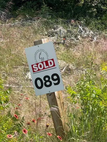 a street sign that is sitting on a rock