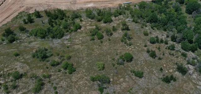 an aerial view of a forest with houses