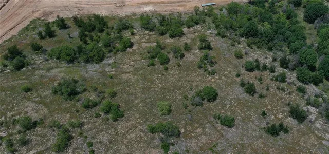 an aerial view of a forest with houses