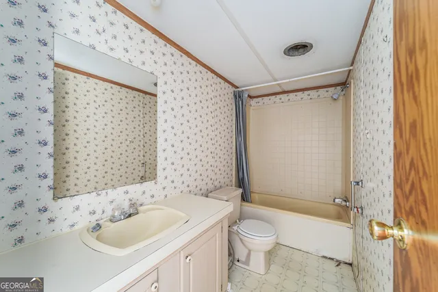 a view of a room with wooden floor and iron stairs