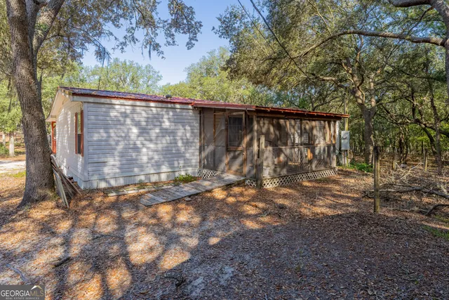a view of a deck in front of a house with wooden fence