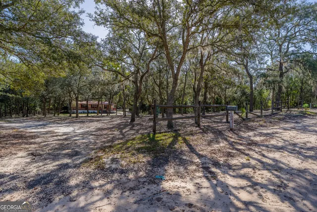 a large bed sitting in a room next to a window