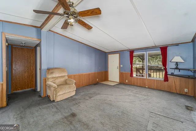 a view of a kitchen with refrigerator and a sink