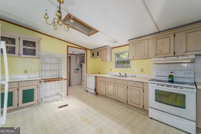 a kitchen with refrigerator and cabinets