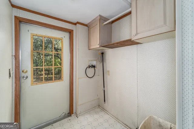 an empty room with a window and a ceiling fan