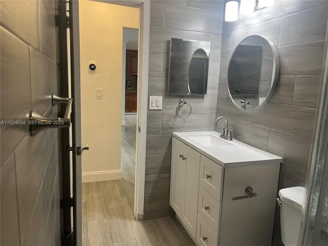 a bathroom with a double vanity sink and a mirror