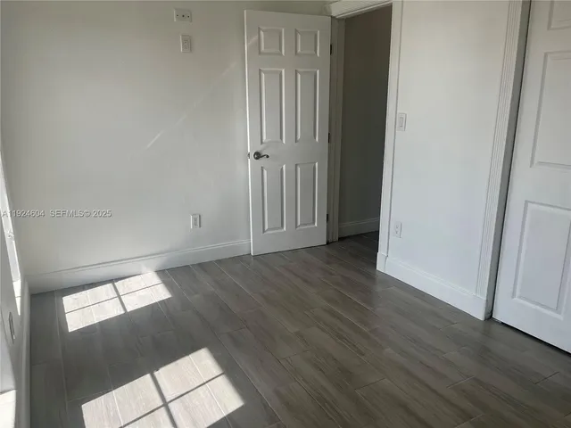 an empty room with wooden floor