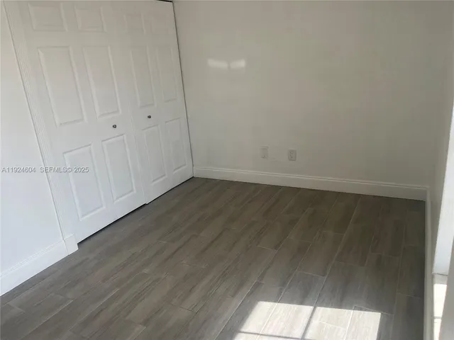 a view of an empty room and wooden floor