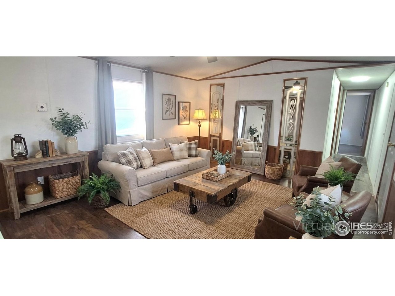 a living room with furniture and a potted plant