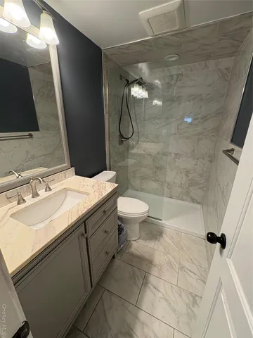 a bathroom with a sink toilet and shower