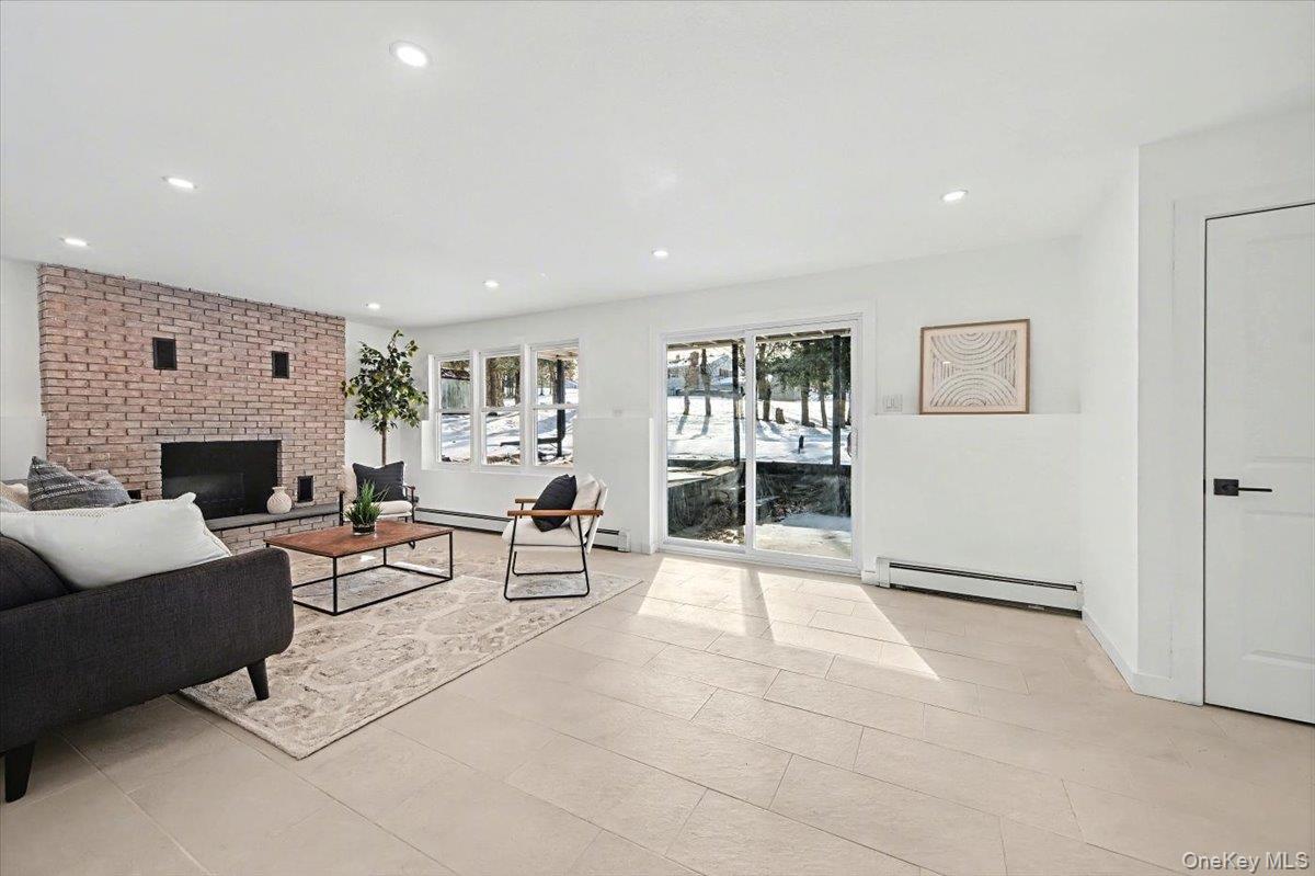 366 Overlook Road Pleasant Valley, NY 12569 - Photo 25 of 39 a living room with furniture a large window and a fireplace