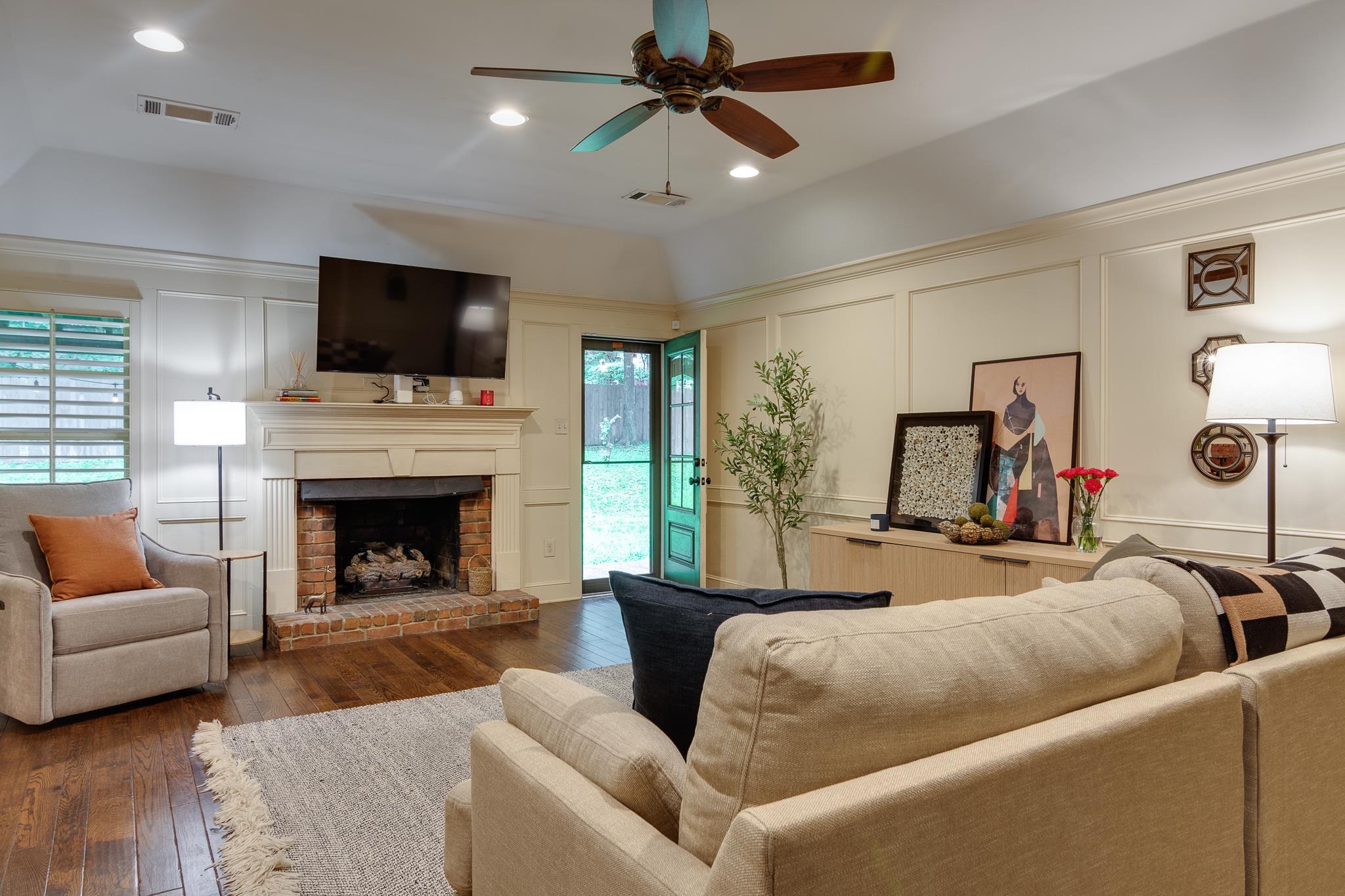 791 North Tree Drive Collierville, TN 38017 - Photo 11 of 27 Living area featuring wood-finish flooring and a brick-surround fireplace with a classic mantel