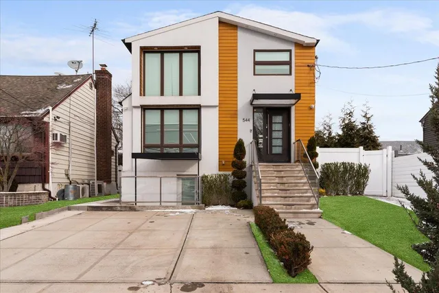 a front view of a house with a garden