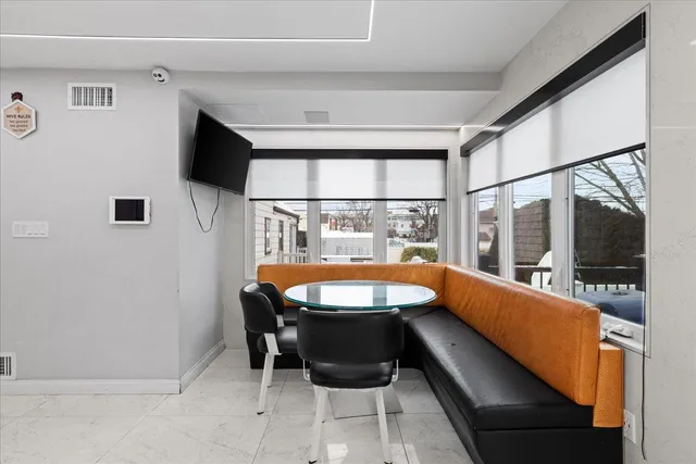 a dining room with a large window table and chairs