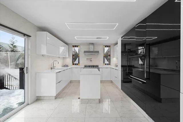 a kitchen with white cabinets and appliances
