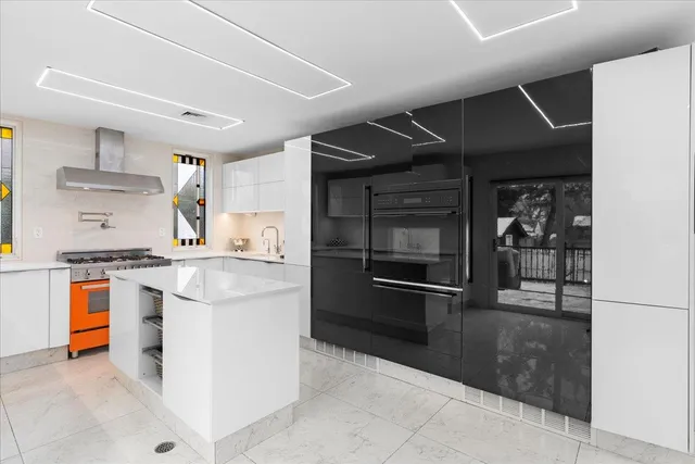 a kitchen with stainless steel appliances granite countertop a stove and a refrigerator