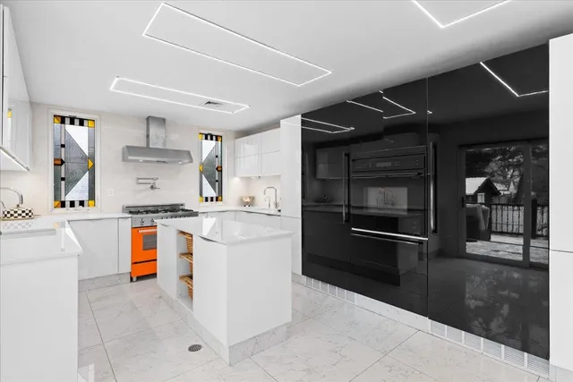 a kitchen with stainless steel appliances kitchen island granite countertop a stove and a sink