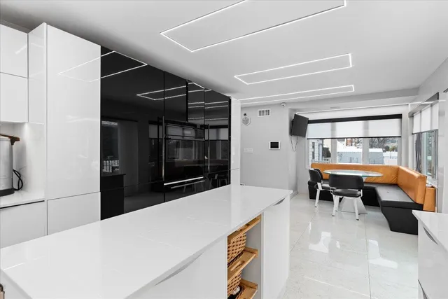 a kitchen with a refrigerator and a table