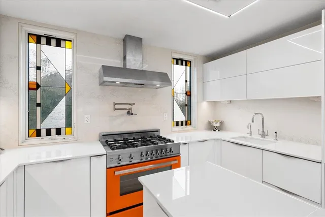 a kitchen with stainless steel appliances granite countertop a sink stove and cabinets