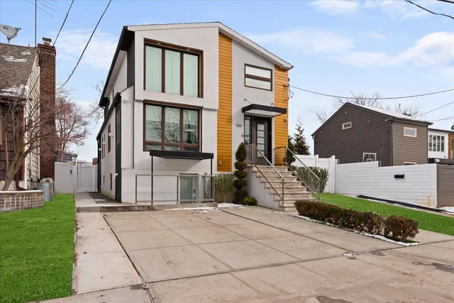 a front view of a house with a garden