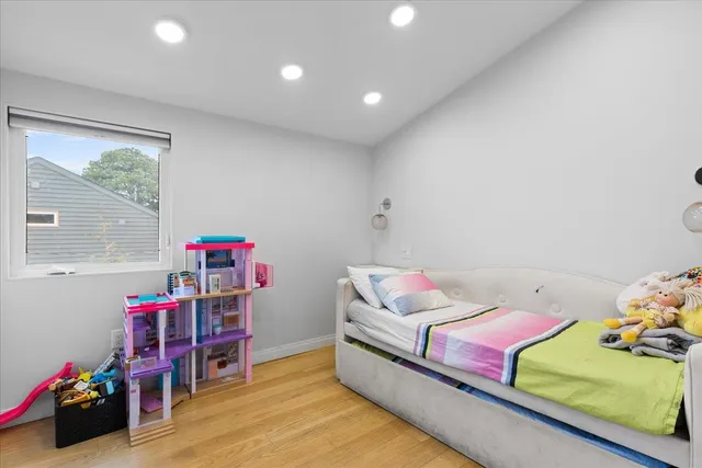 a bedroom with furniture and a window