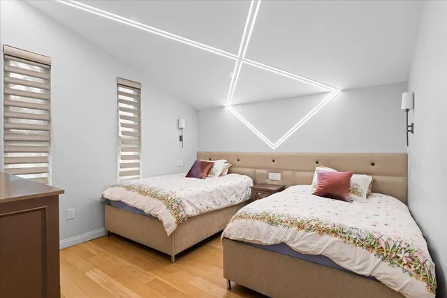 a bedroom with two beds and a window