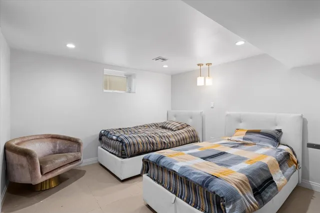 a bedroom with two beds and a couch