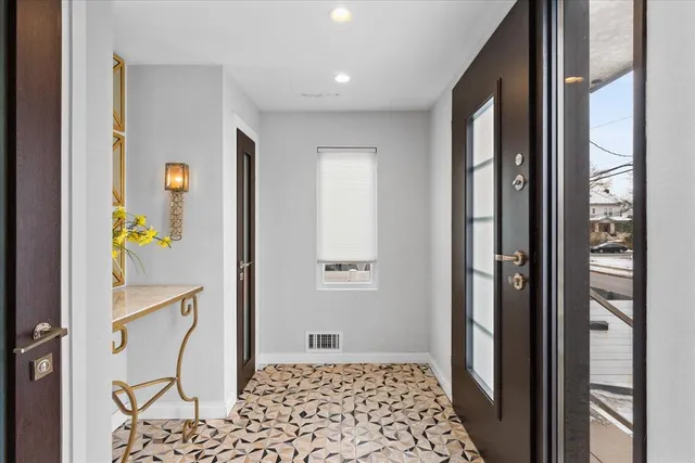 a view of a hallway with windows and stairs