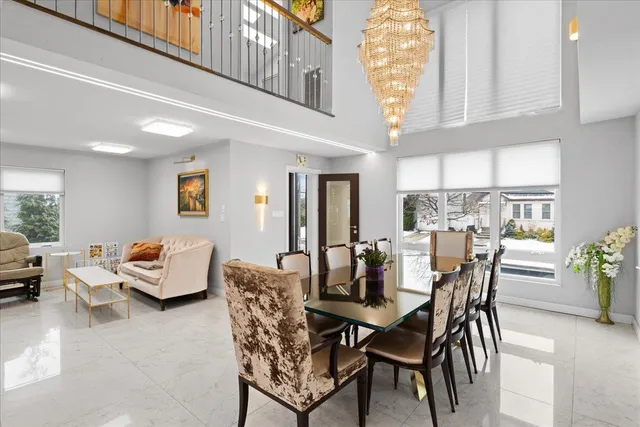 a dining room with furniture a large window and potted plants