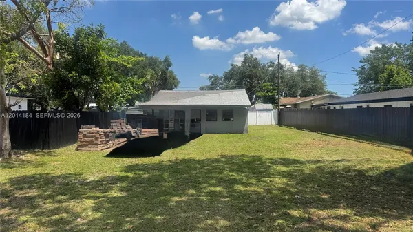 a view of a house with backyard porch and sitting area