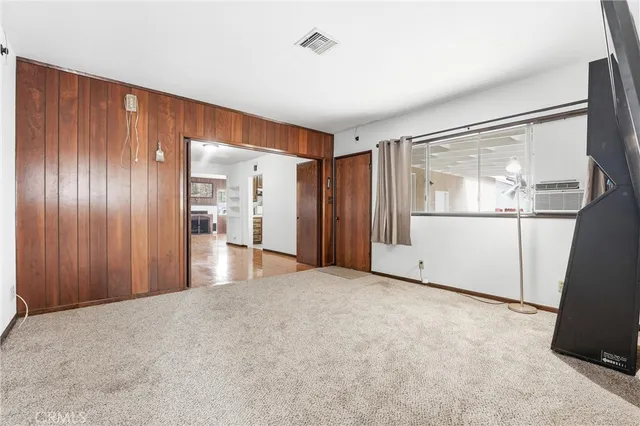 a view of an empty room with a kitchen