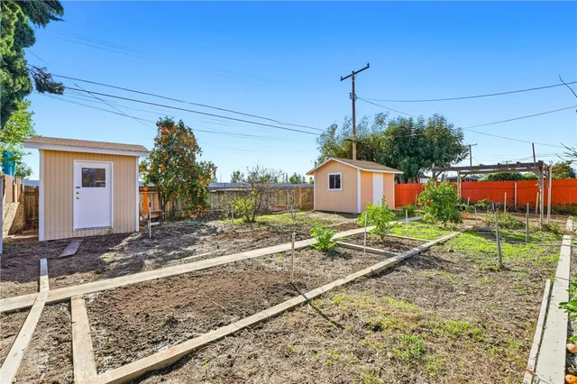 a backyard of a house with table and chairs