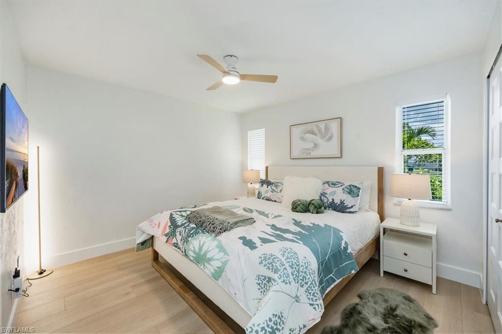 4523 Fluvia Avenue Naples, FL 34103 - Photo 11 of 20 a bedroom with a bed and a window