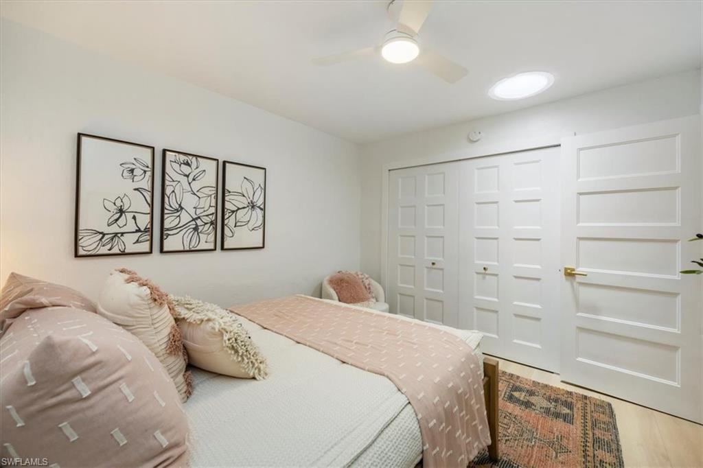 4523 Fluvia Avenue Naples, FL 34103 - Photo 16 of 20 a bedroom with a large bed and a window