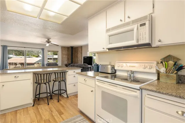 a view of a hallway with a livingroom and a bathroom with mirror